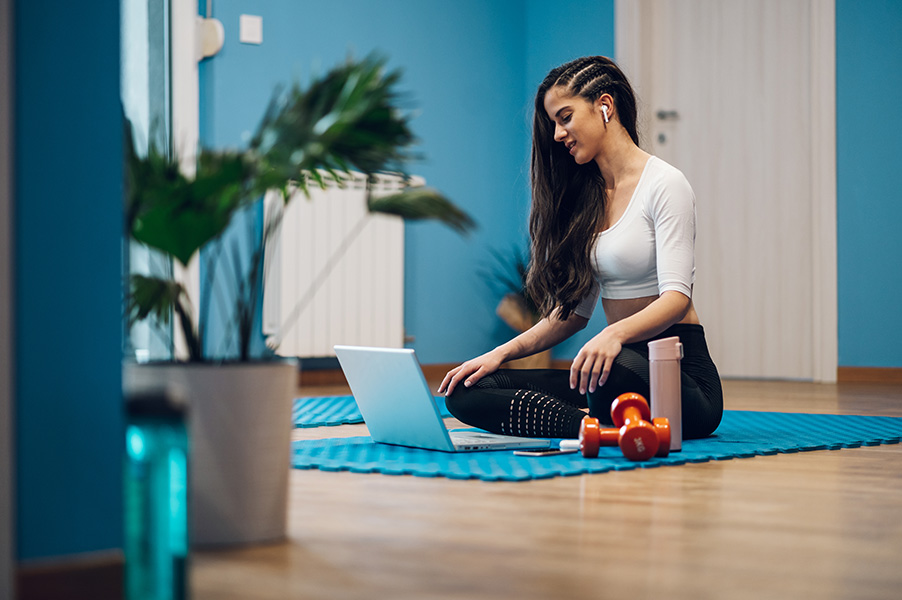 woman-training-at-home-and-coaching-an-online-fitness